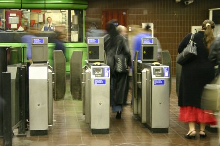 People going through ticket barriers on the Tube